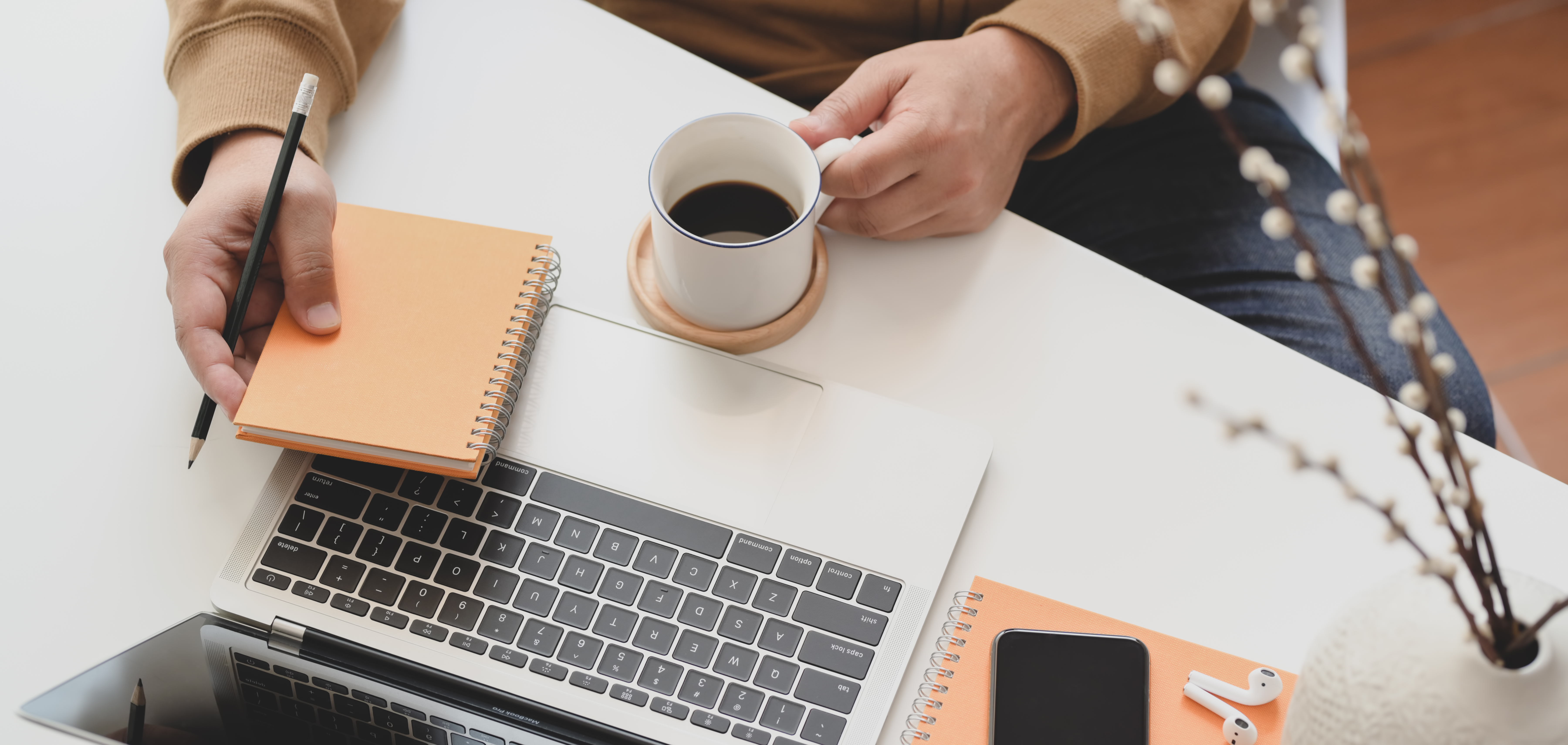 person-holding-white-ceramic-mug-beside-macbook-pro-3787300